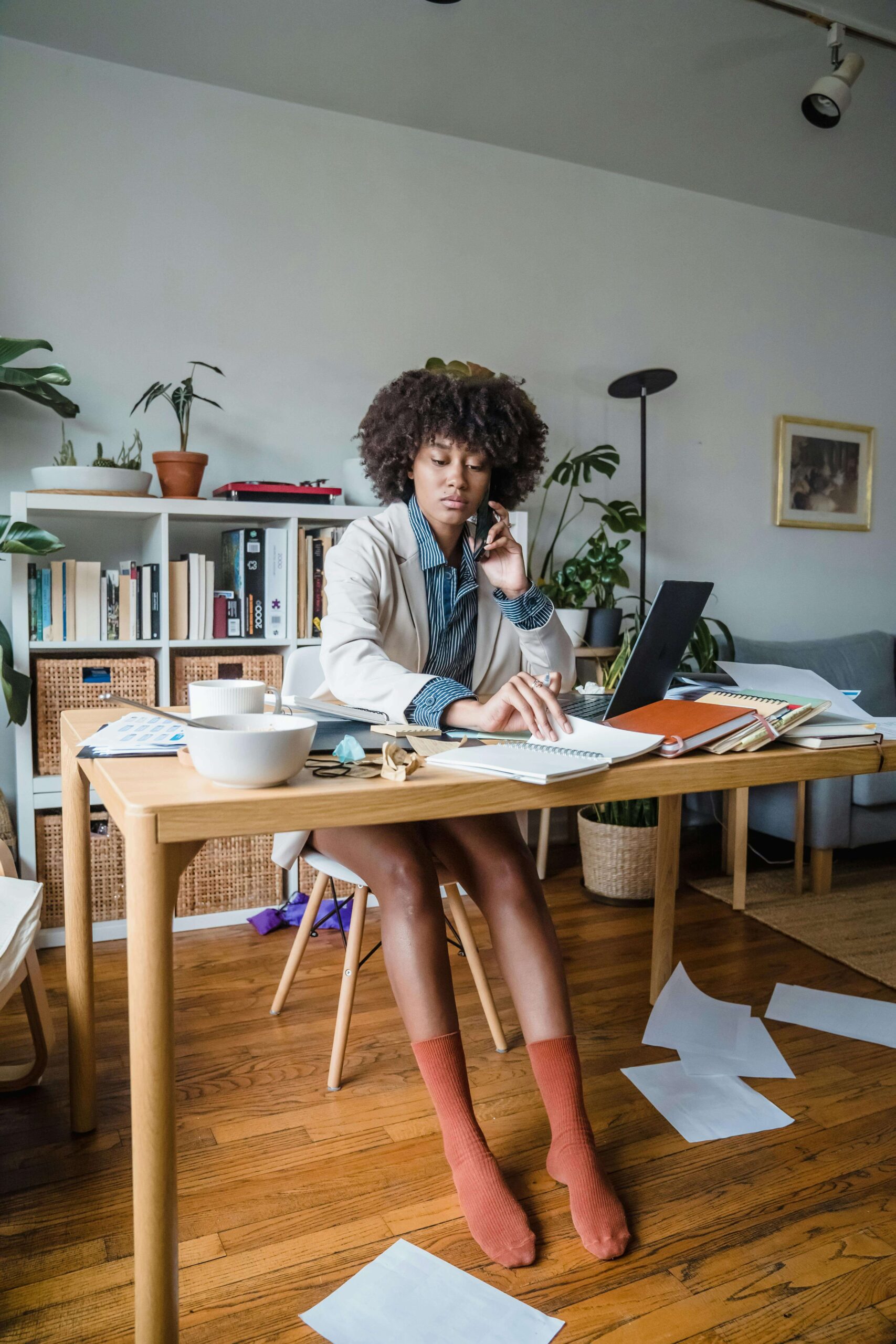 A woman sits at her desk representing a small business owner working on web design.